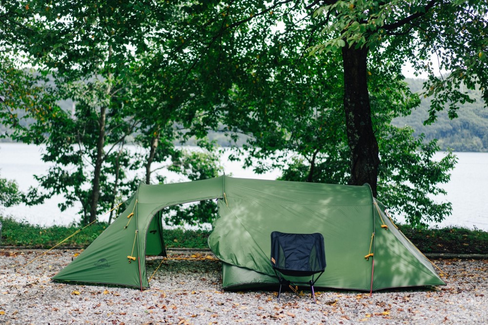 a green tent in a Japanese forest