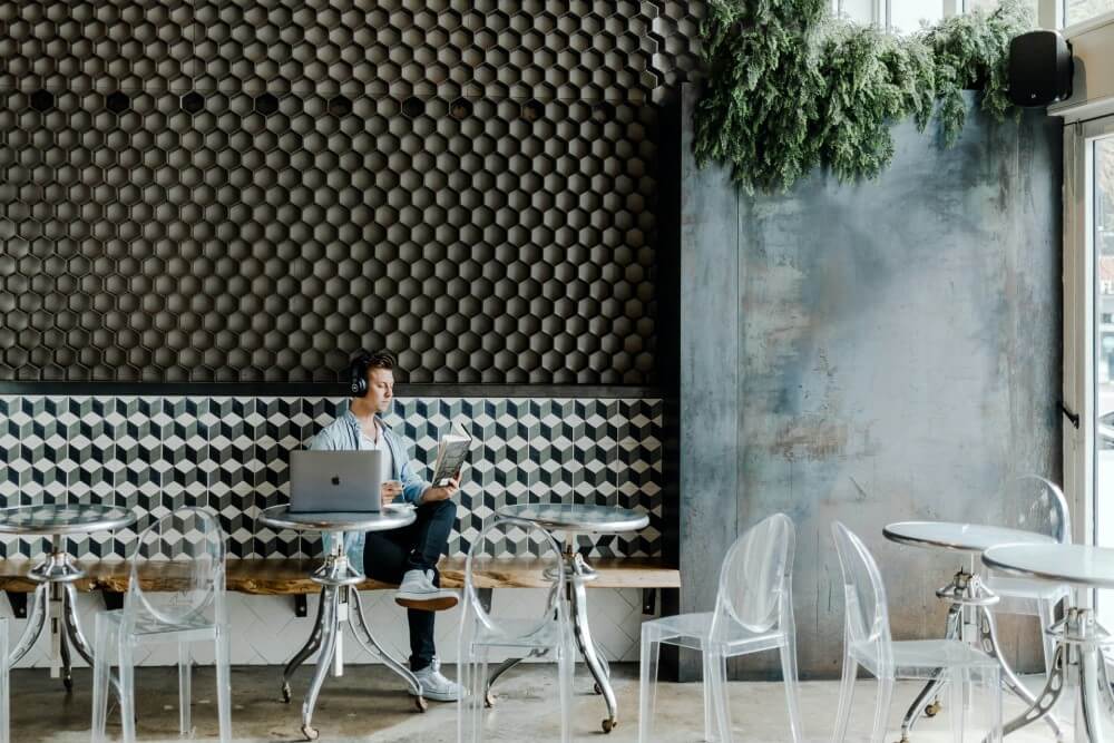 a man sitting in a cafe reading a book