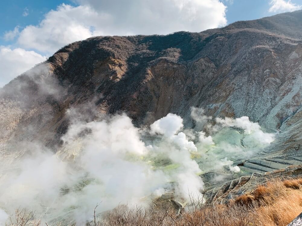 steam rising above a volcano in Japan