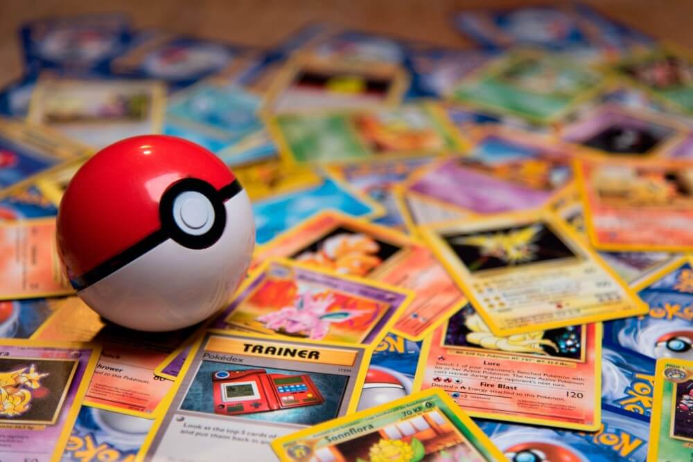 A collection of Pokémon cards and a Pokéball