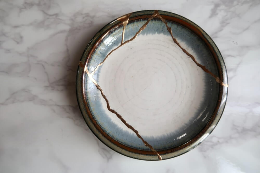 a broken ceramic bowl fixed with gold lacquer