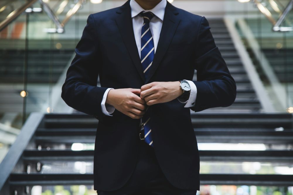 a man with a striped tie and wrist watch