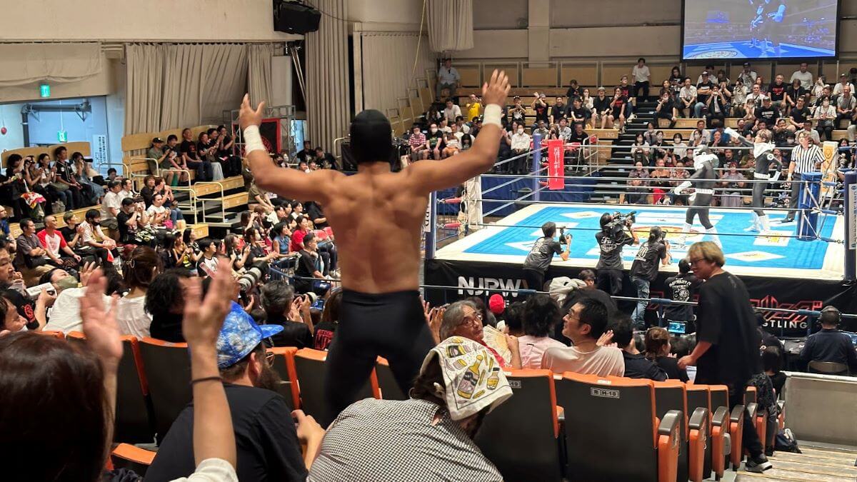 a pro wrestler in Japan standing in the audience